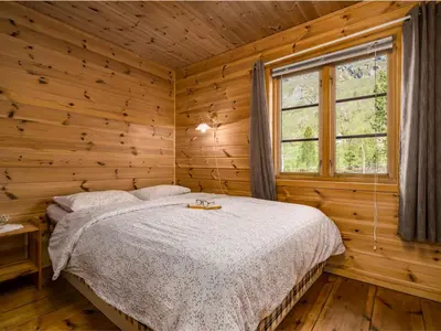 a bedroom with a bed in a log cabin at Holiday Home Lona by Interhome in Viksdalen