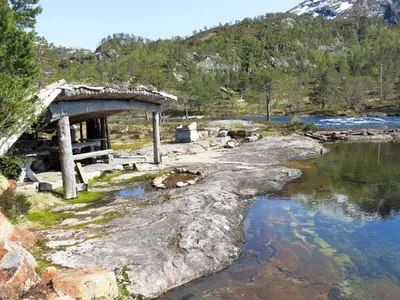 a bridge over a river next to a mountain at Holiday Home Lona by Interhome in Viksdalen