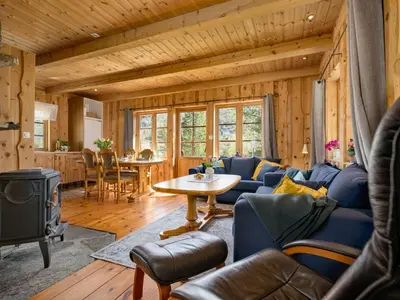 a living room with a blue couch and a table at Holiday Home Myravatnet by Interhome in Viksdalen