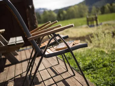 a wooden chair sitting on top of a wooden deck at Holiday Home Myravatnet by Interhome in Viksdalen
