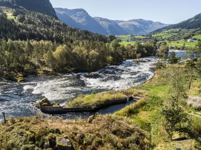 a river in a valley with mountains in the background at Holiday Home Strandbu by Interhome in Viksdalen