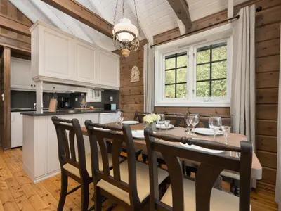 a kitchen and dining room with a table and chairs at Holiday Home Strandbu by Interhome in Viksdalen