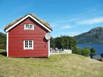 a red house with a grass roof on top of a hill at Holiday Home Havsblikk by Interhome in England