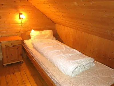 a bed in a cabin with a wooden wall at Holiday Home Havsblikk by Interhome in England