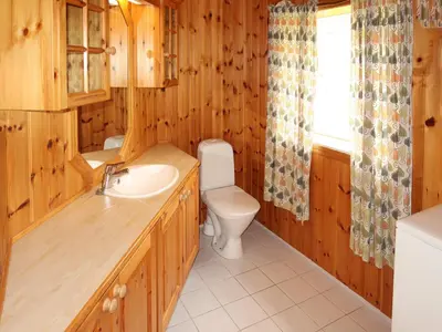 a bathroom with a toilet and a sink at Holiday Home Havsblikk by Interhome in England