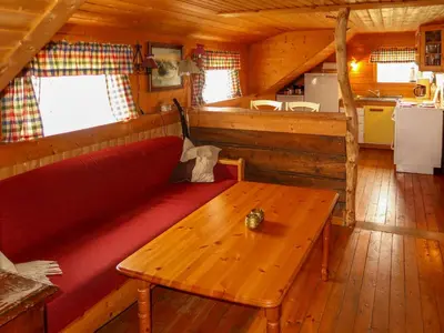 a living room with a red couch and a wooden table at Holiday Home Havsblikk by Interhome in England