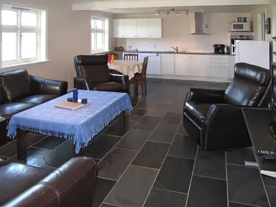 a living room with leather furniture and a table at Apartment Galanten by Interhome in Lunde