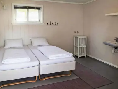 two beds in a room with a sink at Apartment Galanten by Interhome in Lunde