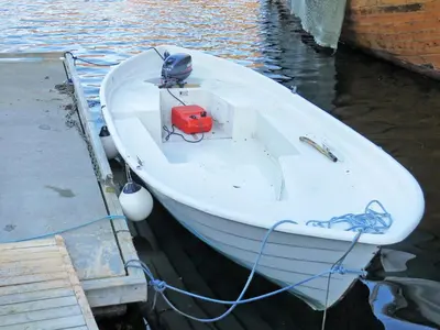 a white boat tied to a dock in the water at Holiday Home Tufto by Interhome in Lunde