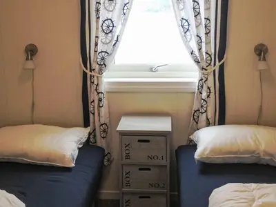 a small room with two beds and a window at Holiday Home Tufto by Interhome in Lunde