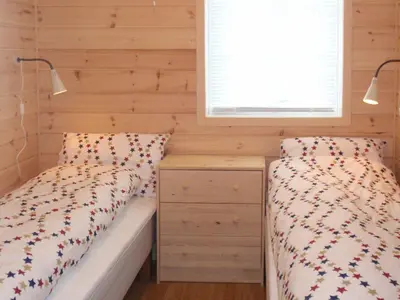 a bedroom with two beds and a window at Holiday Home Blåbærhytta by Interhome in Onarheim