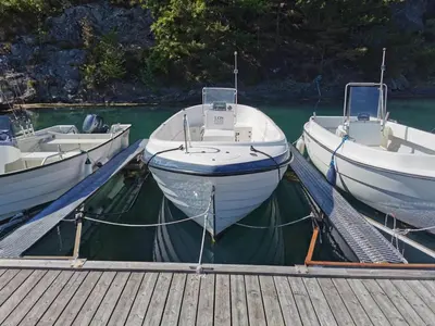 three boats are docked at a dock in the water at Holiday Home Tyttebærhytta by Interhome in Onarheim