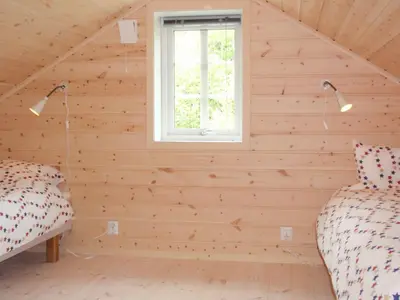 a room with two beds and a window at Holiday Home Tyttebærhytta by Interhome in Onarheim
