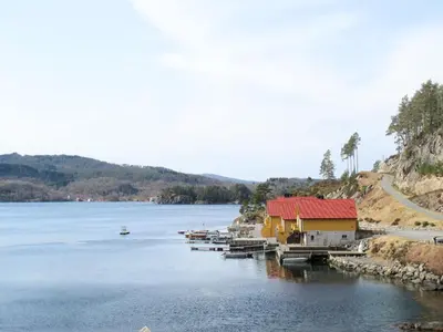 a group of boats docked at a dock on a lake at Apartment Rorbuen by Interhome in Uggdal