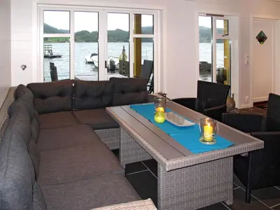 a living room with a couch and a table at Apartment Rorbuen by Interhome in Uggdal