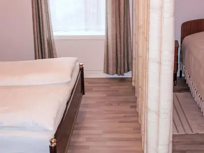 a bedroom with two beds and a window at Holiday Home Bjørkeneset by Interhome in Uggdal