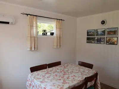 a room with a table and two chairs and a window at Holiday Home Bjørkeneset by Interhome in Uggdal