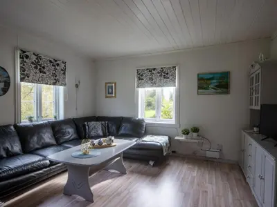 a living room with a couch and a table at Chalet Gulehuset by Interhome in Gjelland