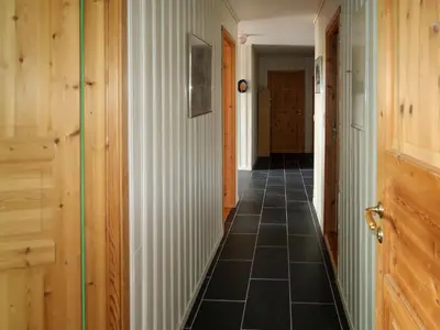 a hallway with a tile floor and wooden walls at Holiday Home Gule huset by Interhome in Bruntveit
