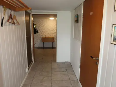 a hallway with a door and a tile floor at Holiday Home Gamlahuset by Interhome in Bruntveit