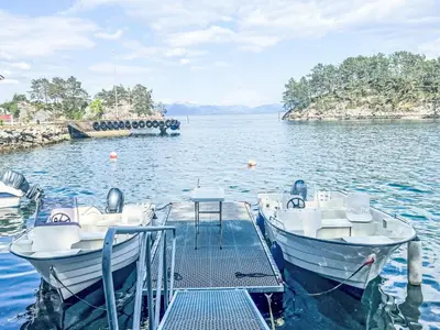 a dock with two boats on the water at Holiday Home Gamlahuset by Interhome in Bruntveit