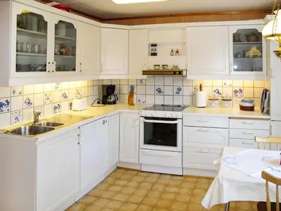 a white kitchen with white cabinets and a sink at Holiday Home Gamlahuset by Interhome in Bruntveit