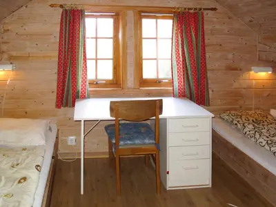 a bedroom with a desk in a log cabin at Chalet Elisabeth by Interhome in Eikelandsosen