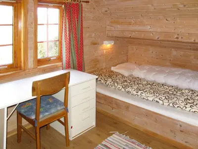 a bedroom with a desk and a bed at Chalet Elisabeth by Interhome in Eikelandsosen