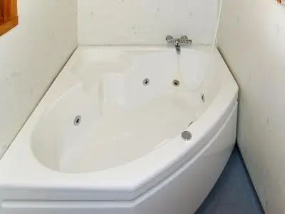 a white bath tub in a bathroom at Chalet Elisabeth by Interhome in Eikelandsosen