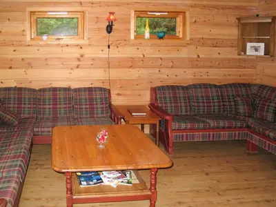 a living room with couches and a coffee table at Chalet Julie by Interhome in Eikelandsosen