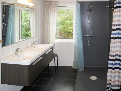 a bathroom with a sink and a window at Chalet Julie by Interhome in Eikelandsosen