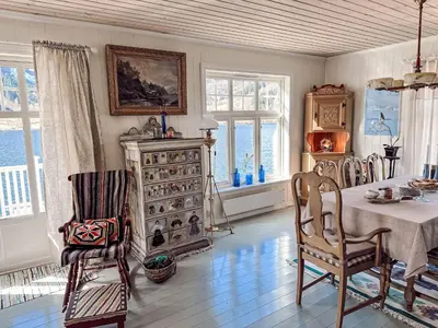 a dining room with a table and chairs and a dresser at Chalet Villa Esefjord by Interhome in Balestrand