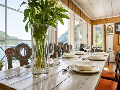 a wooden table with a vase of flowers on it at Holiday Home Eseviki by Interhome in Balestrand