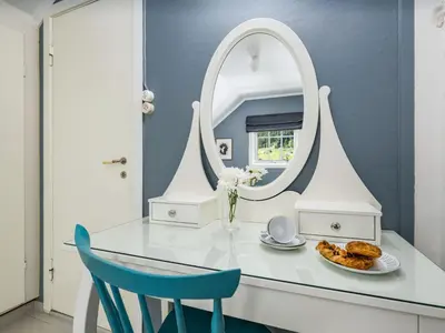 a dressing table with a mirror and a plate of food at Holiday Home Eseviki by Interhome in Balestrand