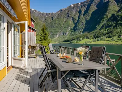 a table on a deck with a view of a lake at Holiday Home Eseviki by Interhome in Balestrand
