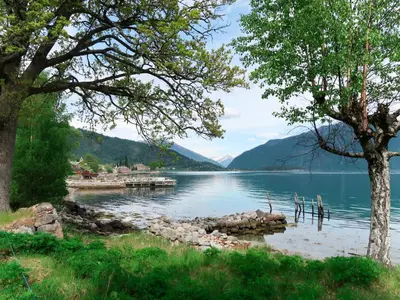 a view of a lake with trees and a dock at Chalet Naustet by Interhome in Balestrand