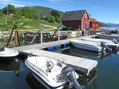 a group of boats are docked at a dock at Holiday Home Tantestova by Interhome in Balestrand