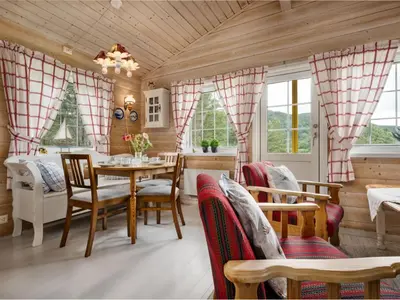 a dining room with a table and chairs at Holiday Home Granlien by Interhome in Gjølanger