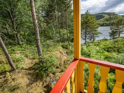 a balcony with a view of a lake and trees at Holiday Home Granlien by Interhome in Gjølanger