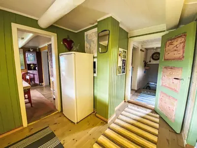 a kitchen with green walls and a refrigerator at Holiday Home Lenebu by Interhome in Syvde