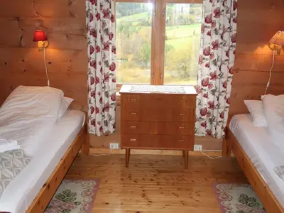 a small room with two beds and a window at Holiday Home Elvehuset by Interhome in Holsen