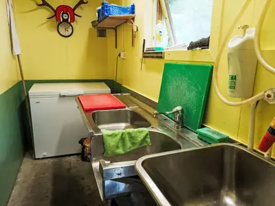 a small kitchen with a sink and a refrigerator at Apartment Mjellhaugen by Interhome in Naustdal i Sunnfjord