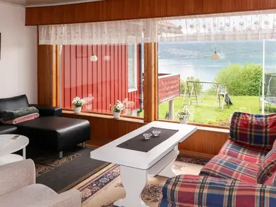 a living room with a couch and a table and a window at Apartment Mjellhaugen by Interhome in Naustdal i Sunnfjord