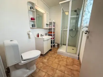 a bathroom with a shower and a toilet and a sink at Holiday Home Kvamsvika by Interhome in Kvammen