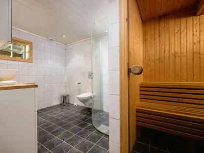 a bathroom with a shower and a toilet and a sink at Holiday Home Frigg by Interhome in Arnefjord
