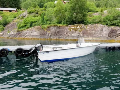 a white boat tied to a dock in the water at Holiday Home Frigg by Interhome in Arnefjord