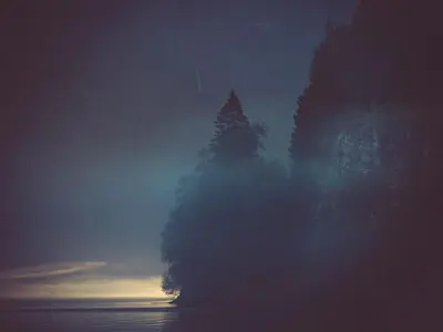 a building with trees in the middle of the water at Holiday Home Frigg by Interhome in Arnefjord