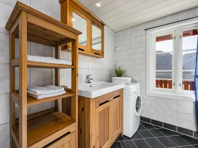 a bathroom with a sink and a washing machine at Holiday Home Tor by Interhome in Arnefjord