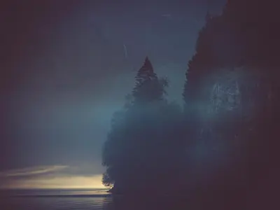 a building with trees in the middle of the water at Holiday Home Tor by Interhome in Arnefjord