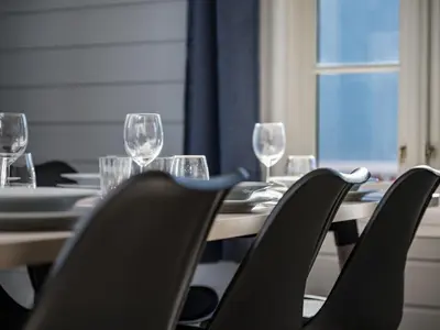 a table with chairs and wine glasses on it at Holiday Home Tor by Interhome in Arnefjord